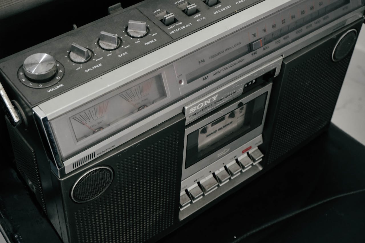 Classic black and silver vintage boombox with cassette player and radio dials.